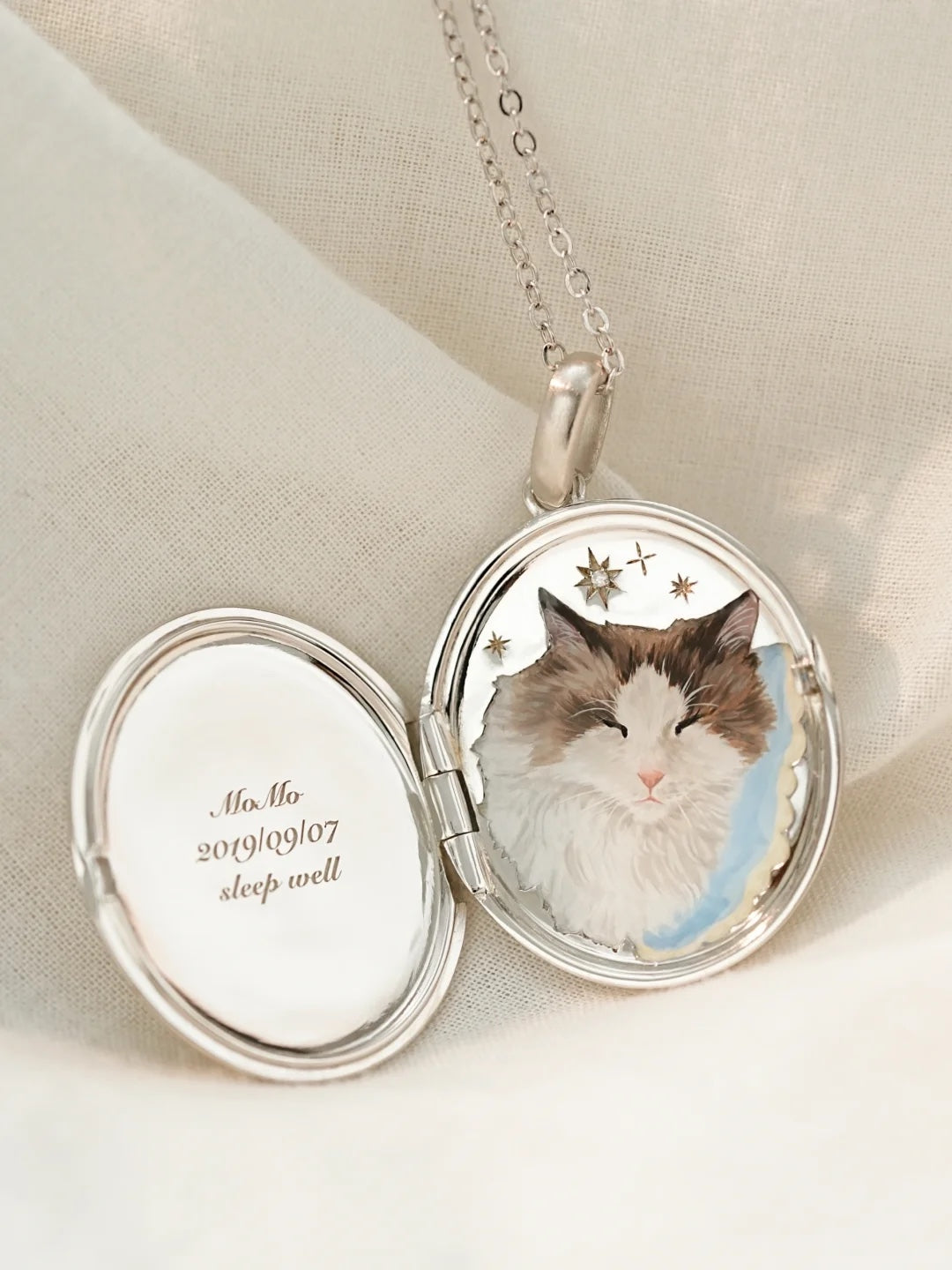 Open custom pet portrait locket with miniature pet paintings