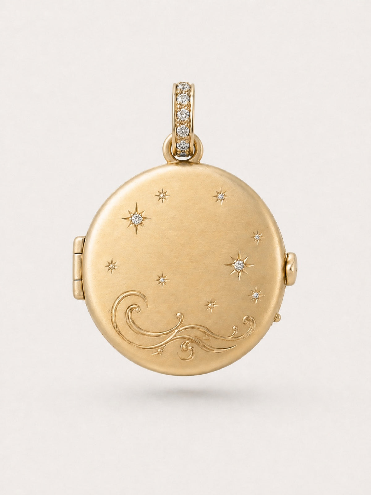 Gold celestial locket back with star and wave engraving