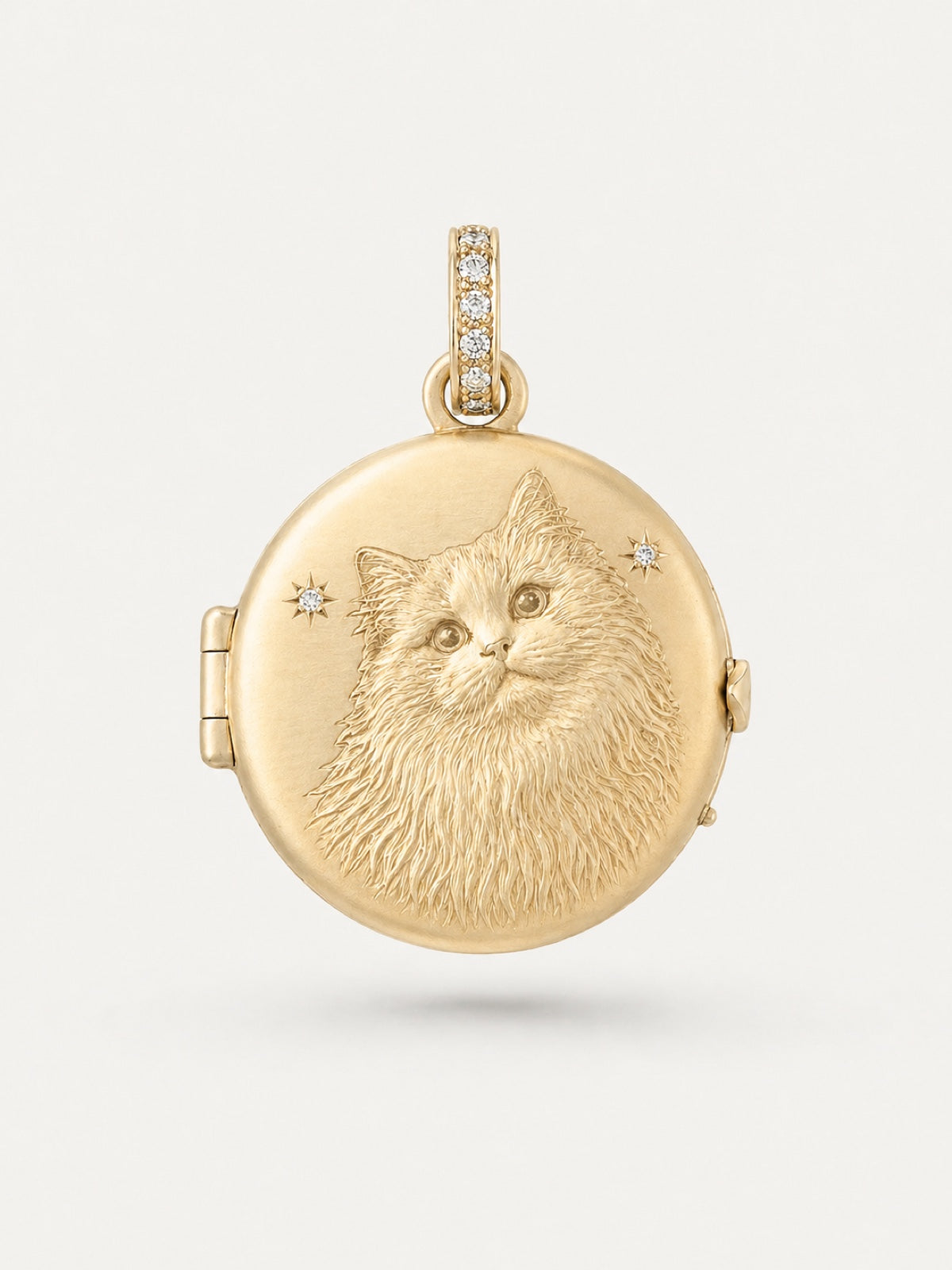 Gold engraved cat portrait locket with diamond star details